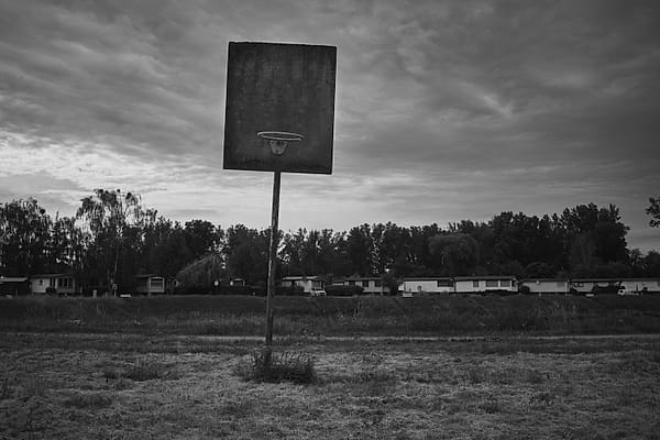 Solitary Backboard - This evocative monochrome study captures a profound sense of stillness and quiet abandonment within a rural landscape