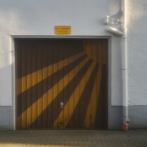 Diagonal Morning Light - A quiet interplay of light and structure transforms a mundane urban entrance into a study of geometric warmth