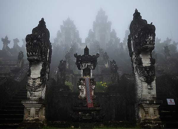 Veiled Temple Ascent - A heavy, ethereal mist blankets an ancient stone structure, obscuring the path upward and creating a sense of profound mystery and spiritual isolation