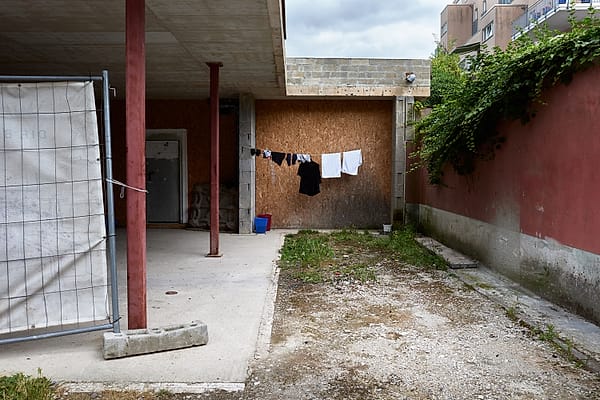Quiet Concrete Courtyard - A quiet moment of everyday life is preserved within a raw, semi-industrial domestic space