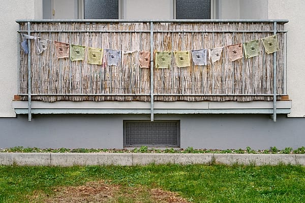 Faded Summer Bunting - A serene exploration of domestic stillness and weathered texture