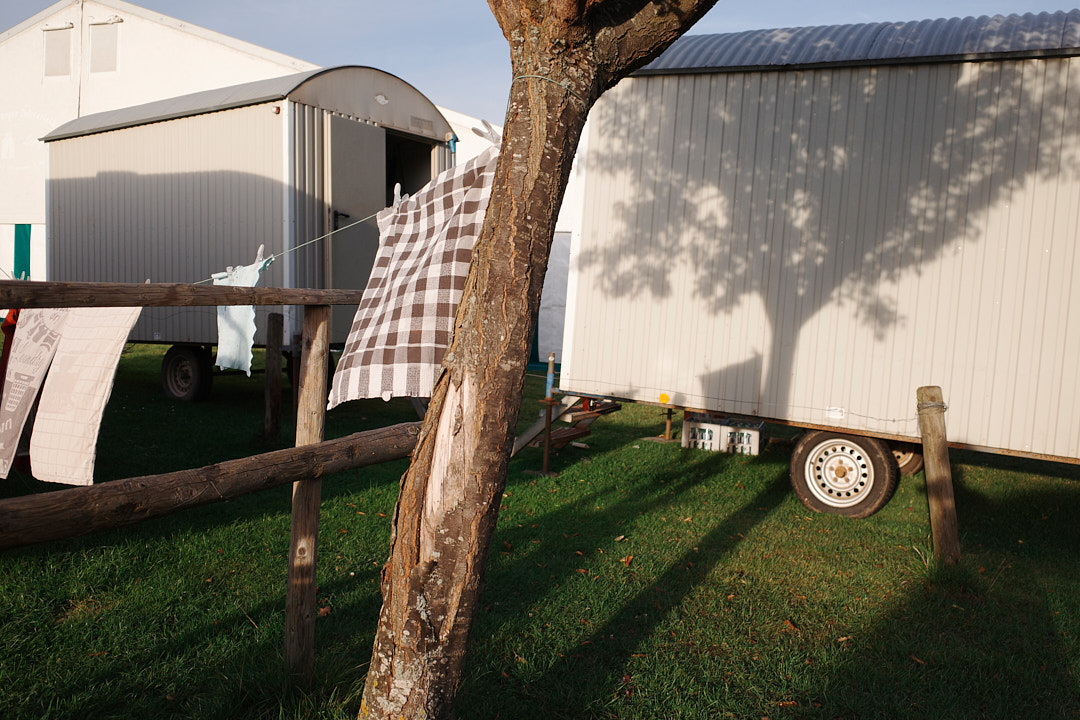 Rustic Shadows in Golden Light - The scene captures a profound quietude found at the intersection of temporary living and natural surroundings
