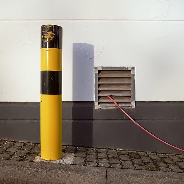 Industrial Color Study - This piece captures a serene moment of structural interplay, balancing bold primary colors against a backdrop of neutral urban textures